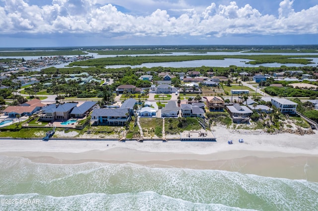 drone / aerial view with a water view and a view of the beach