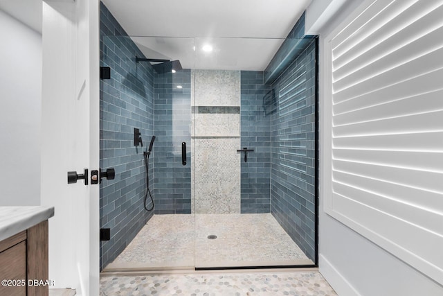 bathroom featuring a shower with shower door and tile patterned flooring