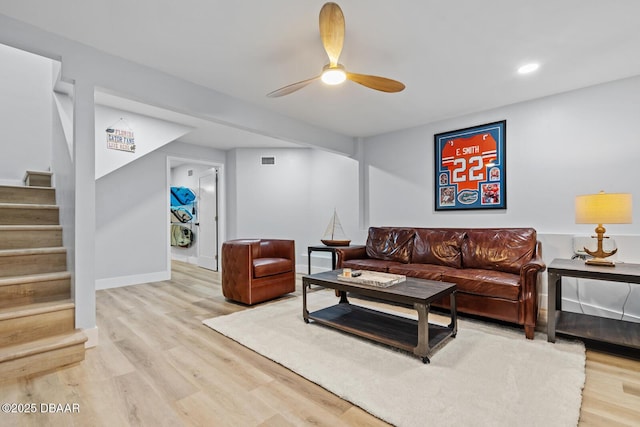 living room with ceiling fan and light wood-type flooring