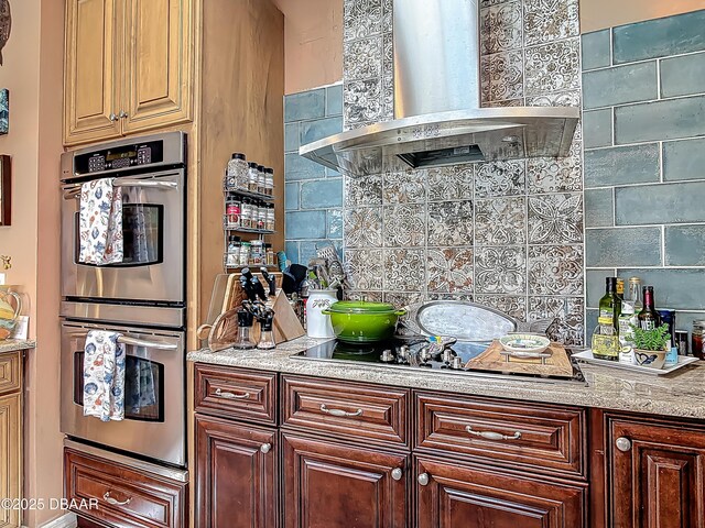 31 Sea Harbor Dr E Unit E, Ormond Beach, FL 32176 - kitchen with island exhaust hood, stainless steel double oven, decorative backsplash, and black electric cooktop