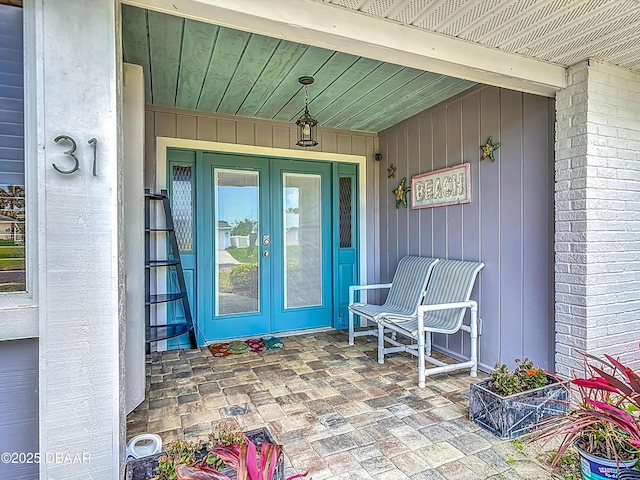 31 Sea Harbor Dr E Unit E, Ormond Beach, FL 32176 - view of exterior entry featuring french doors and brick siding