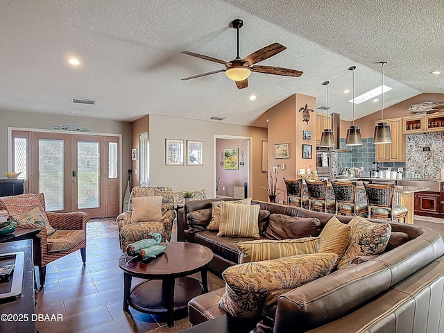 31 Sea Harbor Dr E Unit E, Ormond Beach, FL 32176 - living room with a textured ceiling, ceiling fan, lofted ceiling, french doors, and recessed lighting