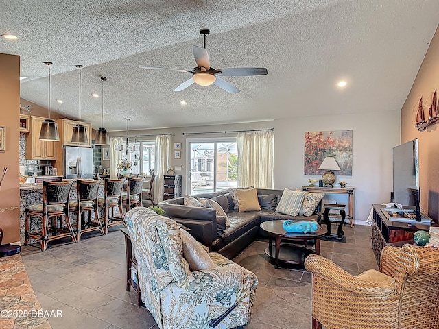 31 Sea Harbor Dr E Unit E, Ormond Beach, FL 32176 - living area with a textured ceiling, a ceiling fan, lofted ceiling, recessed lighting, and light stone finish floors