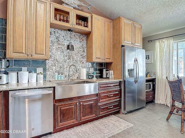 31 Sea Harbor Dr E Unit E, Ormond Beach, FL 32176 - kitchen featuring stainless steel appliances, tasteful backsplash, light stone countertops, and a textured ceiling