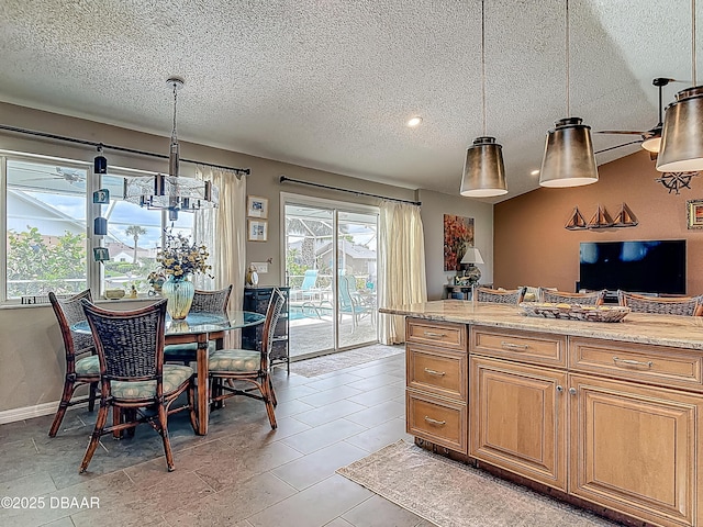 31 Sea Harbor Dr E Unit E, Ormond Beach, FL 32176 - kitchen with a textured ceiling, brown cabinets, hanging light fixtures, and light stone counters