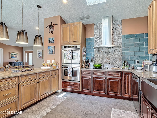 31 Sea Harbor Dr E Unit E, Ormond Beach, FL 32176 - kitchen featuring stainless steel appliances, wall chimney exhaust hood, tasteful backsplash, light stone countertops, and hanging light fixtures
