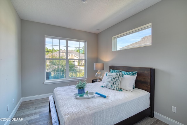 bedroom featuring wood-type flooring and a textured ceiling