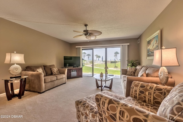 living room with light colored carpet, a textured ceiling, and ceiling fan