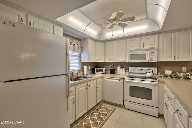 kitchen featuring white cabinets, white appliances, light tile patterned floors, and sink