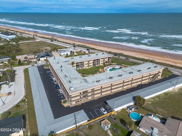 drone / aerial view featuring a view of the beach and a water view