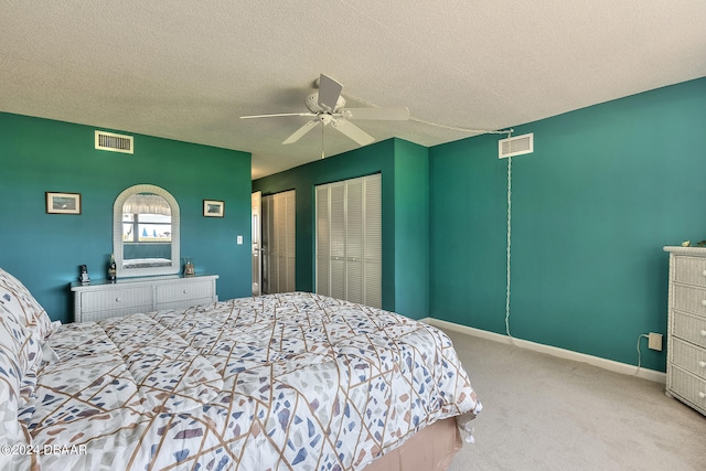 carpeted bedroom featuring a textured ceiling and ceiling fan