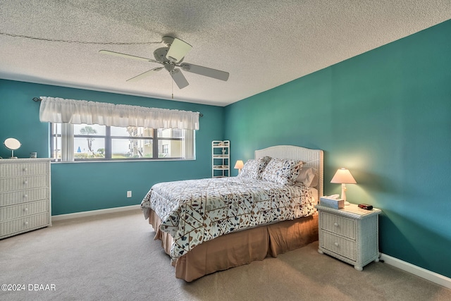 bedroom with carpet, a textured ceiling, and ceiling fan