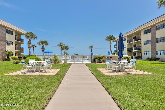 view of home's community featuring a patio and a yard