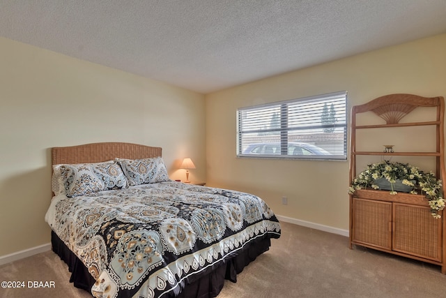 bedroom featuring a textured ceiling and light carpet