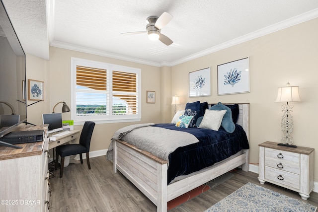 bedroom featuring ceiling fan, hardwood / wood-style floors, a textured ceiling, and ornamental molding