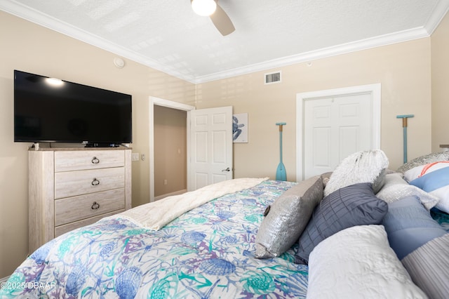 bedroom with a textured ceiling, ceiling fan, and crown molding