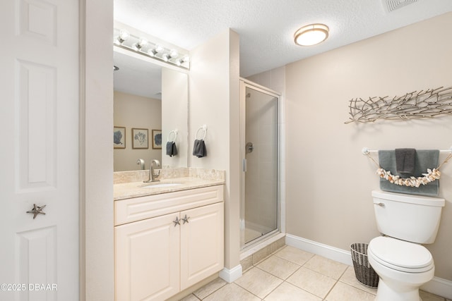 bathroom featuring tile patterned floors, vanity, a textured ceiling, and walk in shower