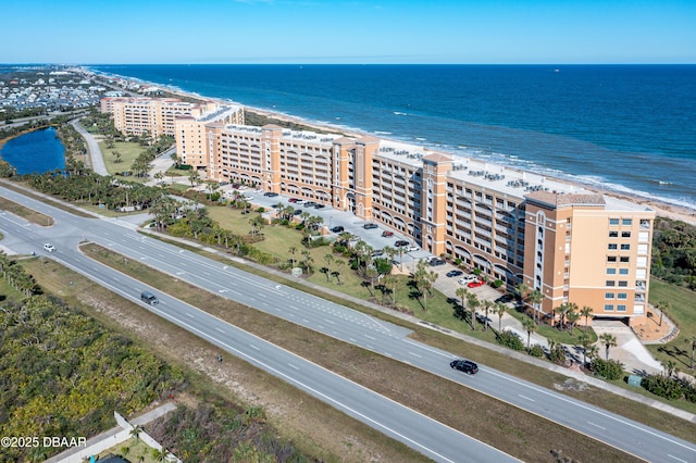 bird's eye view featuring a water view and a beach view