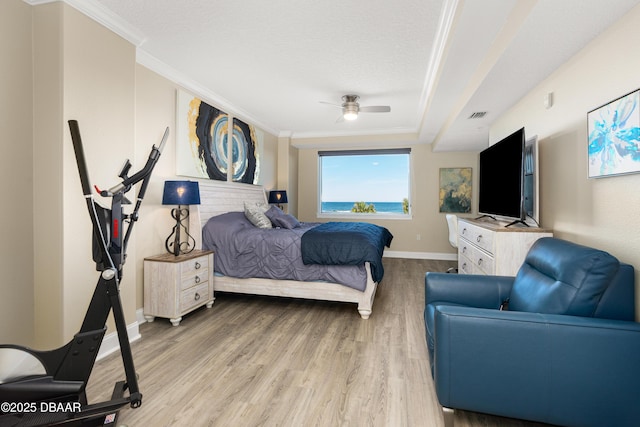 bedroom featuring hardwood / wood-style floors, a textured ceiling, ceiling fan, and crown molding