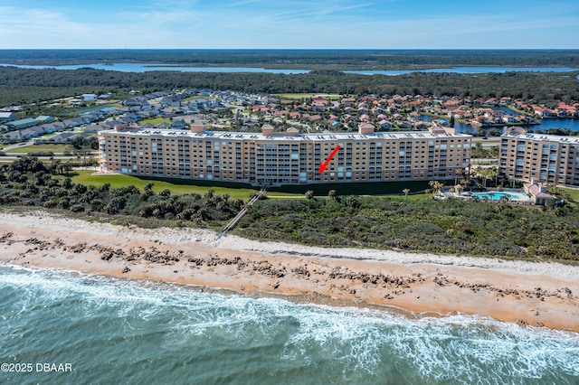 bird's eye view with a water view and a beach view