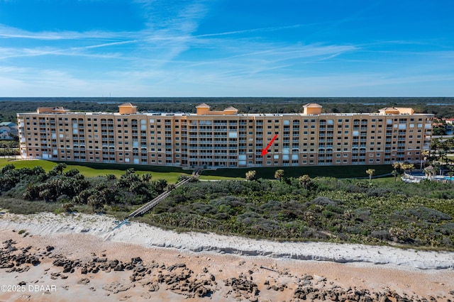 view of property with a beach view and a water view