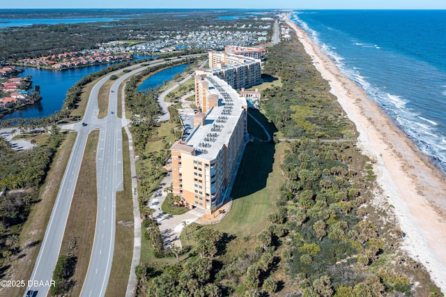 aerial view with a water view and a beach view