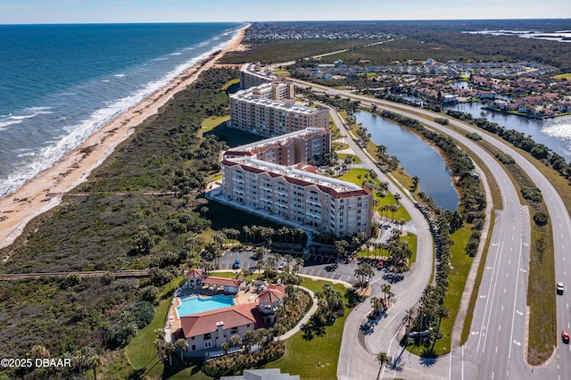 bird's eye view with a water view and a beach view