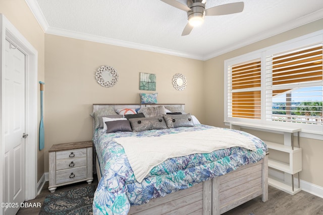 bedroom featuring wood-type flooring, a textured ceiling, ceiling fan, and crown molding