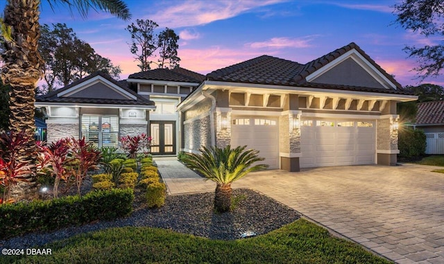 view of front of property with a garage and french doors