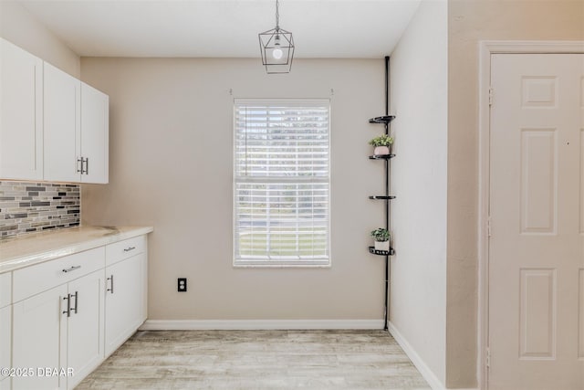 laundry room featuring light wood-type flooring