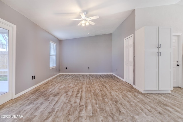 empty room with ceiling fan and light hardwood / wood-style flooring