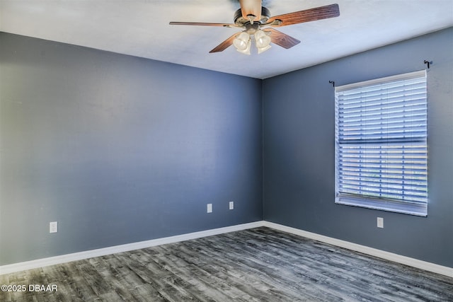 spare room featuring dark hardwood / wood-style floors and ceiling fan