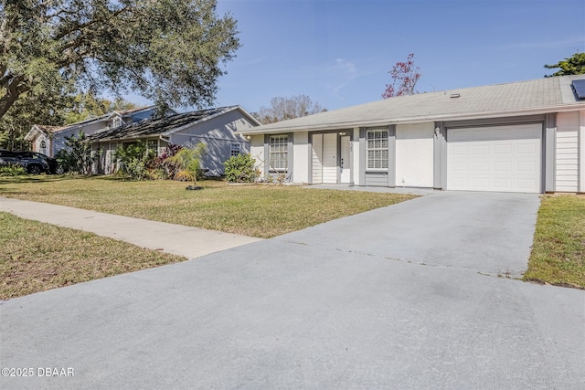 ranch-style home with a garage and a front lawn