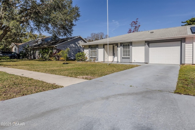 single story home featuring a garage and a front lawn