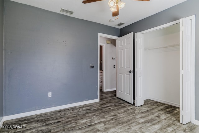 unfurnished bedroom with hardwood / wood-style floors, ceiling fan, and a closet