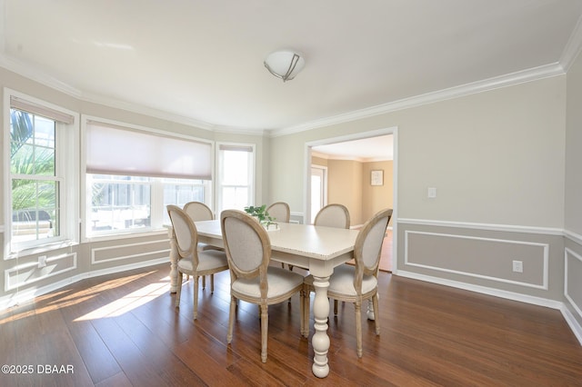 dining room with ornamental molding and dark hardwood / wood-style flooring