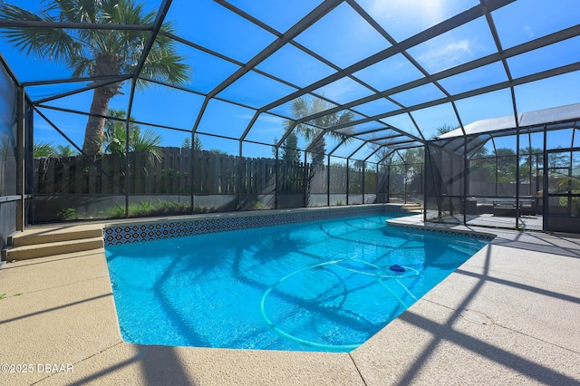 view of swimming pool featuring a patio and a lanai