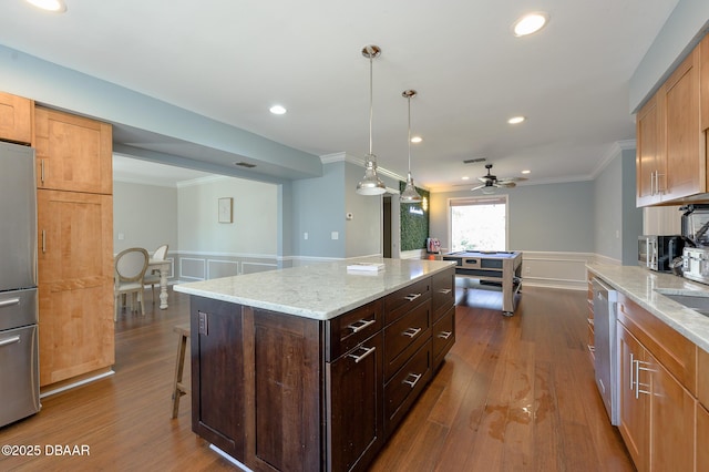 kitchen featuring pendant lighting, stainless steel appliances, dark hardwood / wood-style floors, a center island, and light stone counters