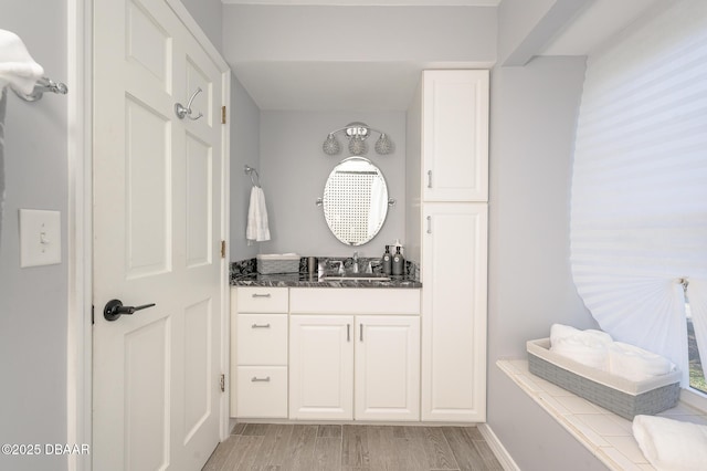 bathroom featuring vanity and hardwood / wood-style flooring