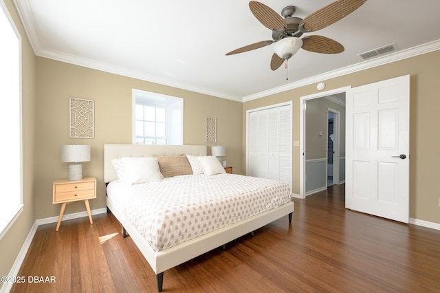 bedroom featuring crown molding, ceiling fan, dark hardwood / wood-style floors, and a closet