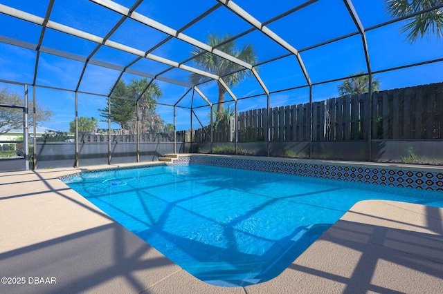 view of pool featuring a patio and glass enclosure