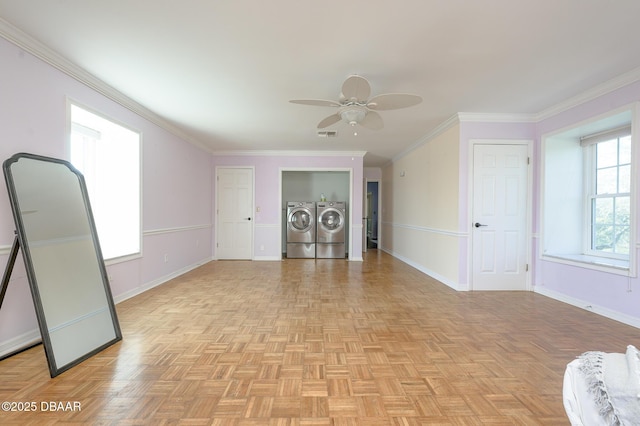 unfurnished living room featuring ornamental molding, a healthy amount of sunlight, and washer and clothes dryer