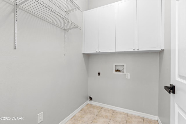 laundry area featuring light tile patterned flooring, cabinets, washer hookup, and electric dryer hookup