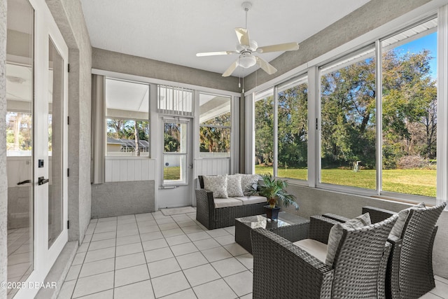 sunroom / solarium with a wealth of natural light and ceiling fan