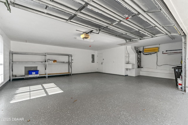 garage with a garage door opener and electric panel