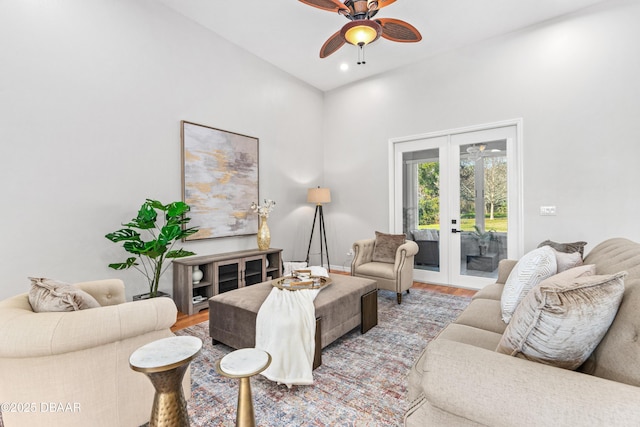 living room featuring french doors, ceiling fan, and light hardwood / wood-style flooring