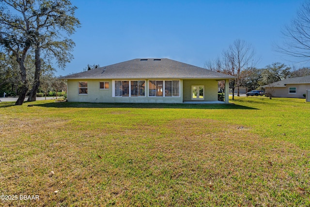 rear view of property with a yard