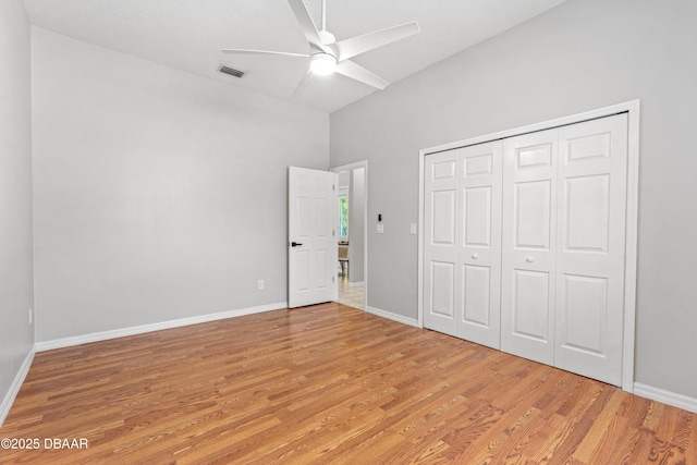 unfurnished bedroom featuring ceiling fan, a closet, and light hardwood / wood-style flooring