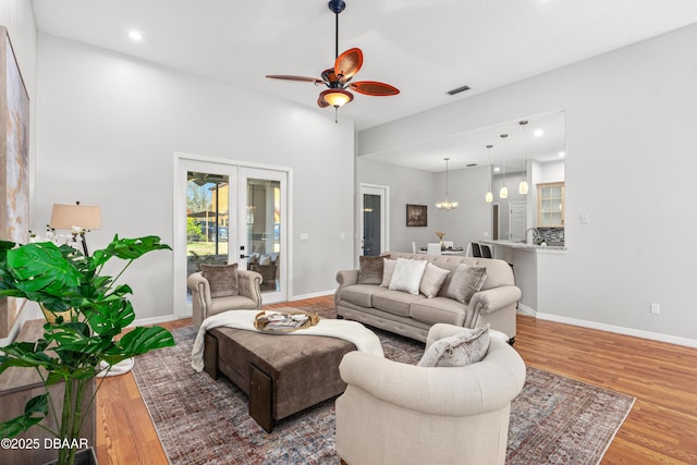 living room featuring hardwood / wood-style floors, french doors, and ceiling fan