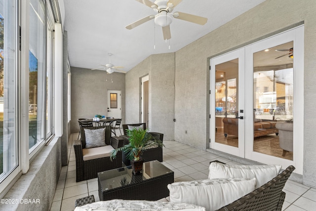 sunroom / solarium with french doors, ceiling fan, and a healthy amount of sunlight